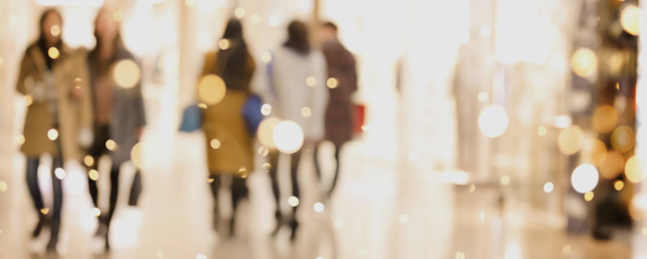 Shoppers walking in a holiday shopping scene