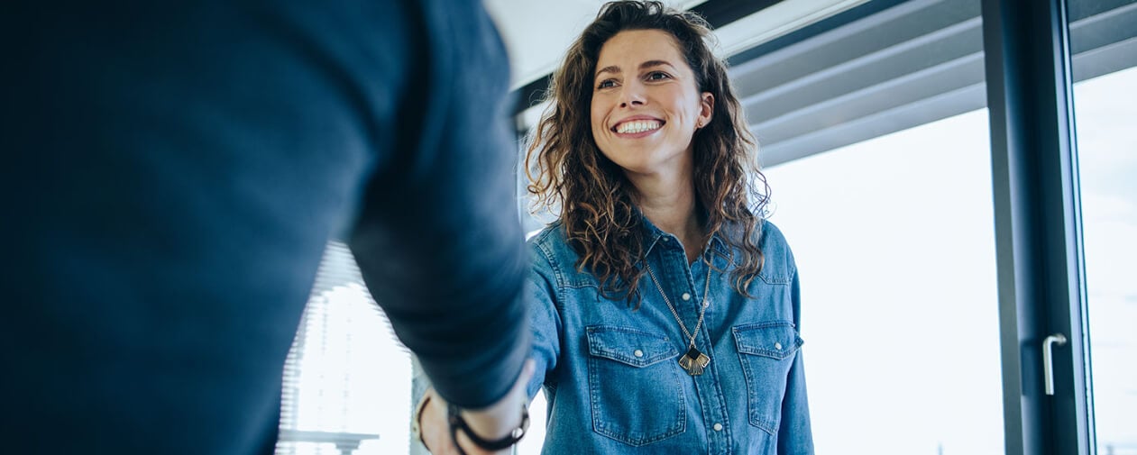 Recruiter greeting a potential sales rep hire