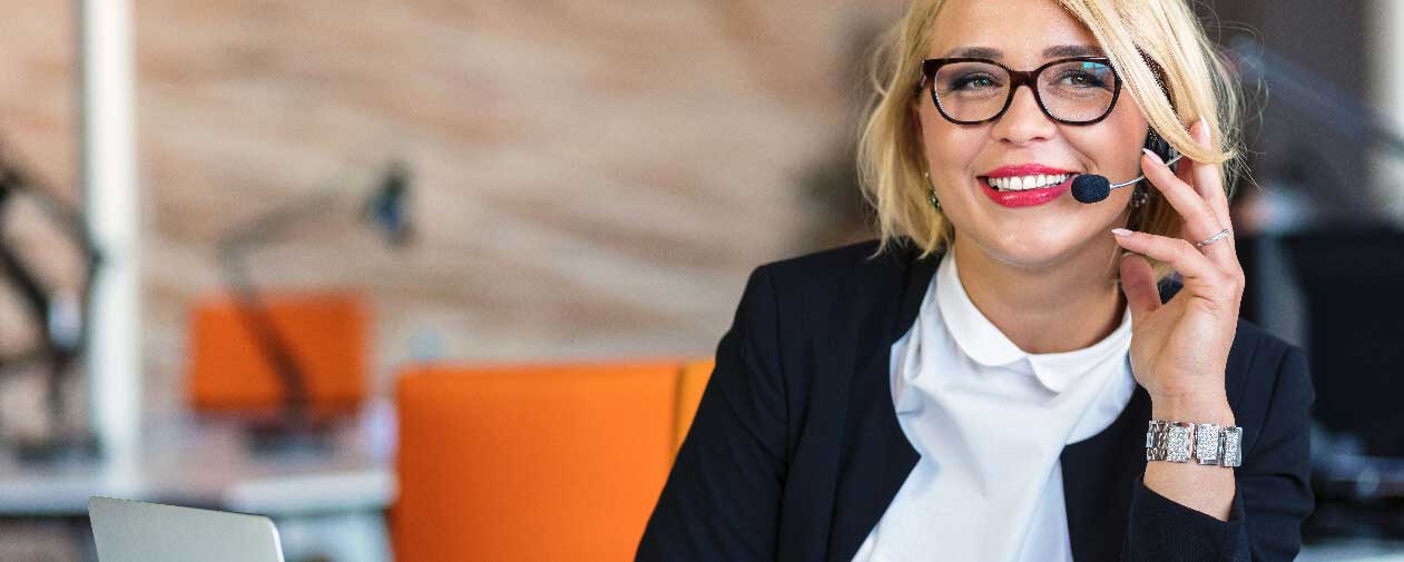 Woman in headset conducting business virtually