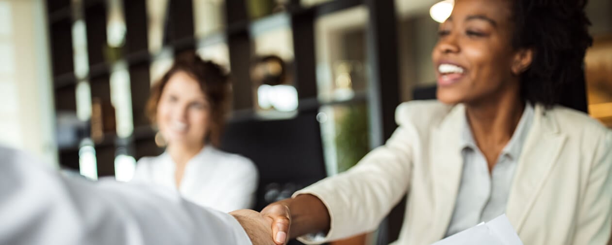 Business woman meeting with somebody, shaking hands.