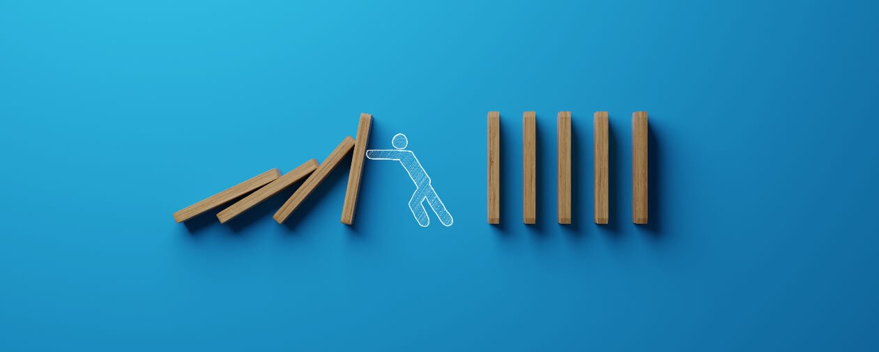 The man stops falling dominoes. The concept of stopping churn.