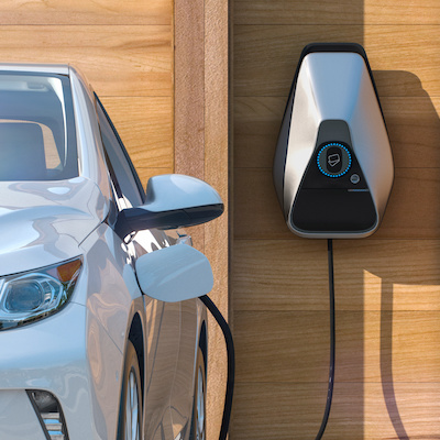 electric car of the future using smart charging at home Electric vehicle using smart electric car charging station at home frontal perspective