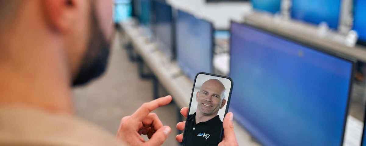 Man in a store on a video chat with an AskMe rep
