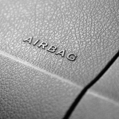 Recall Car dealer working with computer in dealership.